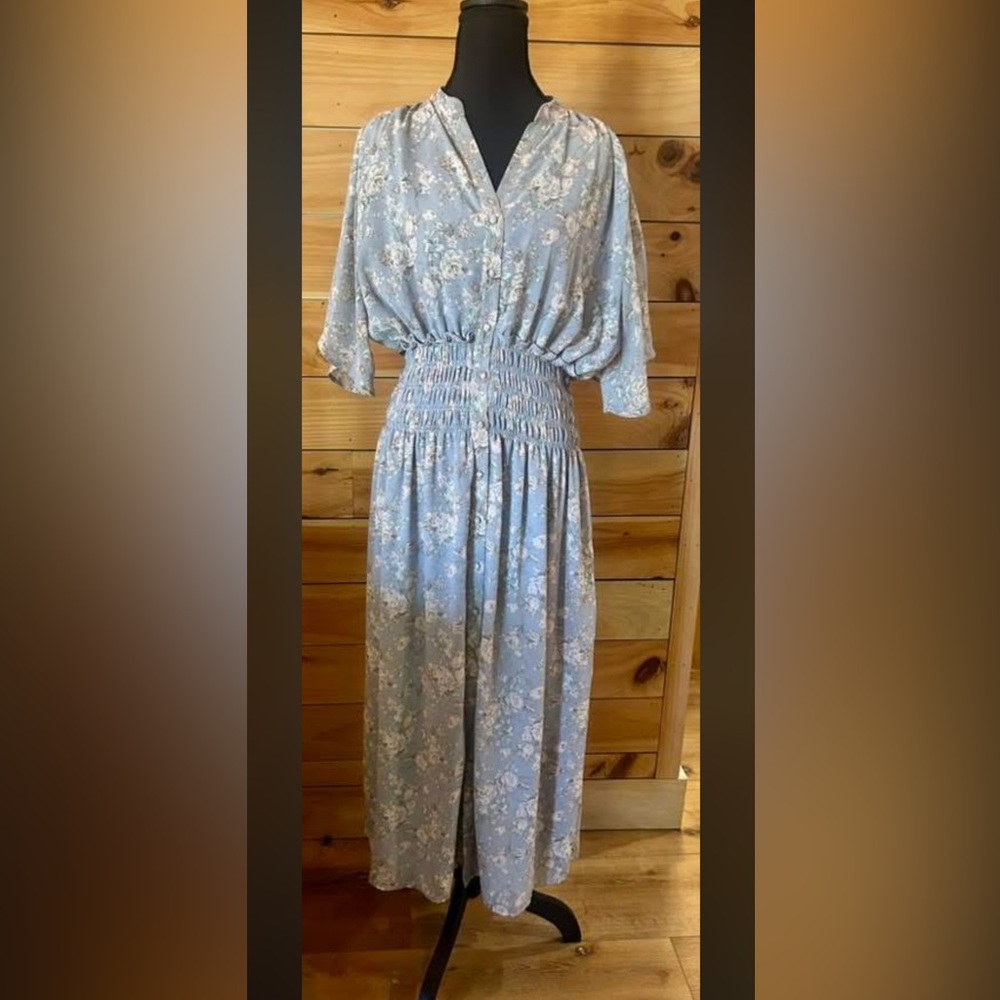 Light Blue with floral pattern, functional buttons all the way down, lined